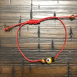 Red string bracelet.